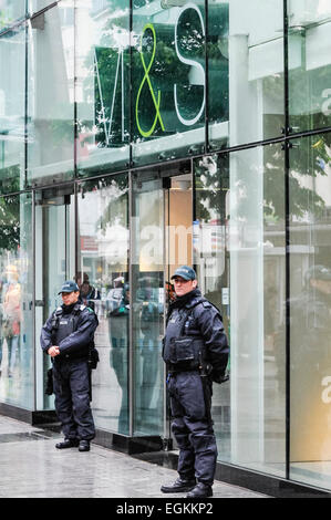 Belfast, Northern Ireland, 15th june 2013. Two police officers guard a branch of Marks and Spencer from potential threat from anti-G8 protesters.  This branch has previously been attacked by pro-Palestinian/anti-israeli protesters Stock Photo