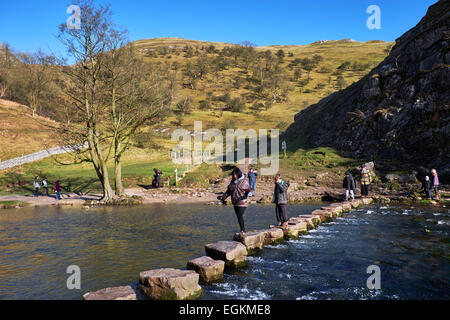 People on the famous Stepping Stones across the River Dove. Dovedale, Derbyshire, England.  [Peak District National Park] Stock Photo