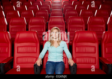 young woman watching movie in theater Stock Photo