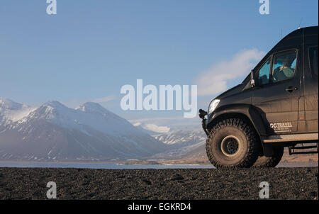 Super jeep stopped by the stunning scenery at Eystrahorn, South East Iceland in February Stock Photo