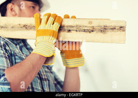 close up of male in gloves carrying wooden boards Stock Photo