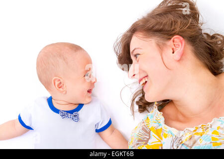 mother talks with her baby boy on white background Stock Photo