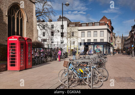 Cambridge street scene - St Andrew's Street, with bicycles, red English telephone boxes, shops and old buildings. Stock Photo