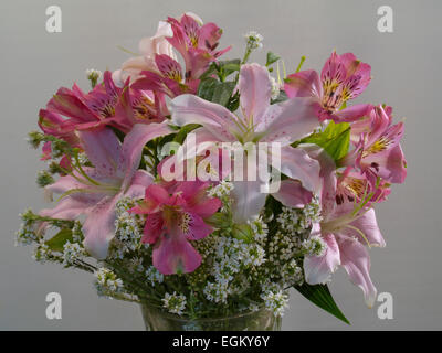 bouquet with pink lilies and orchids(Alstroemeria) (Lilium) gray light background , horizontal Stock Photo