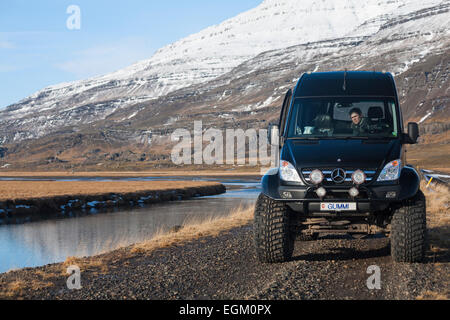 Super jeep stopped by the stunning scenery in Hofsdalur, East Iceland in February Stock Photo
