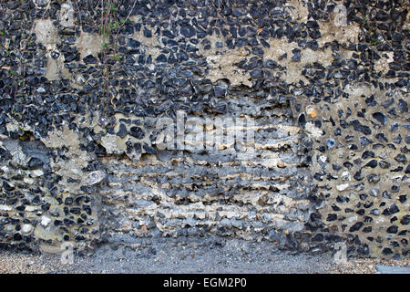 Flint wall with flints dropping out Stock Photo