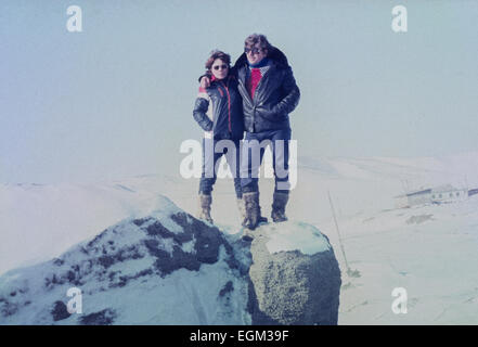 Chukchi Peninsula, USSR - March 22, 1981:Happy young family standing on a rock and looking with hope into the future Stock Photo