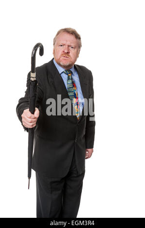 Aggressive middle aged man in suit brandishes umbrella, isolated on white Stock Photo