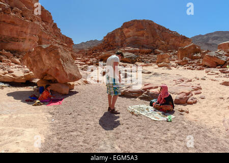 Bedouin kids selling souvenirs in Colored Canyon, Sinai, Egypt. Coloured Canyon is a rock formation and dried riverbed on Sinai Stock Photo