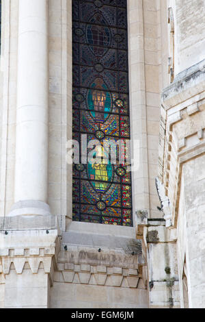 Virgin Mary holding a flowers in her hand on a stained glass window of Basilica of Notre-Dame Stock Photo