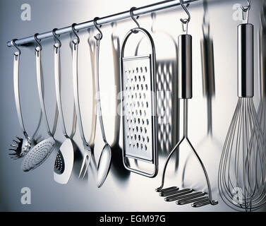 Kitchen Utensils Hanging on Wall Stock Photo