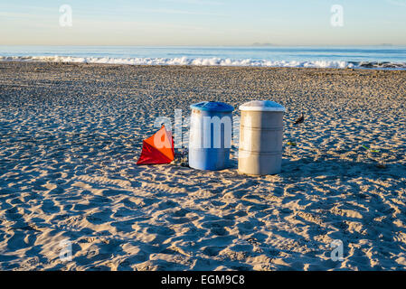 Two trash cans and a beach umbrella on Coronado Central Beach. Coronado,  California, United States. Stock Photo