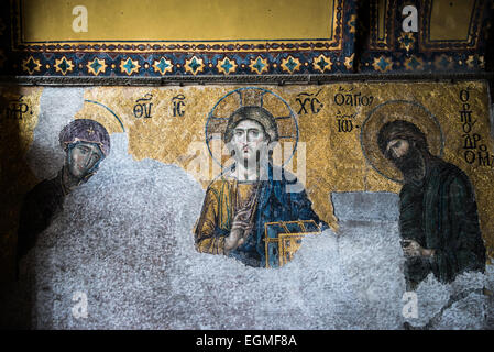 ISTANBUL, Turkey / Türkiye — Dating to around 1261, the Deësis mosaic is located in the imperial closure of the upper galleries of Hagia Sophia. In this panel the Virgin Mary and John the Baptist (Ioannes Prodromos), both shown in three-quarters profile, are imploring the intercession of Christ Pantocrator for humanity on Judgment Day. Originally built in 537, it has served as an Eastern Orthodox cathedral, a Roman Catholic cathedral, a mosque, and now a museum. Also known as Ayasofya or Aya Sofia, it is one of Istanbul's primary landmarks. Stock Photo