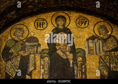 A mosaic depicting the Virgin Mary and child flanked by Justinian I and Constantine I in Hagia Sophia. Dating to the 10th century. On the right is Emperor Constantine holding a model of the city of Constantinople. On the left is Emperor Justinian holding a model of Hagia Sophia. Originally built in 537, it has served as an Eastern Orthodox cathedral, a Roman Catholic cathedral, a mosque, and now a museum. Also known as Ayasofya or Aya Sofia, it is one of Istanbul's primary landmarks. Stock Photo