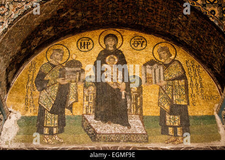 A mosaic depicting the Virgin Mary and child flanked by Justinian I and Constantine I in Hagia Sophia. Dating to the 10th century. On the right is Emperor Constantine holding a model of the city of Constantinople. On the left is Emperor Justinian holding a model of Hagia Sophia. Originally built in 537, it has served as an Eastern Orthodox cathedral, a Roman Catholic cathedral, a mosque, and now a museum. Also known as Ayasofya or Aya Sofia, it is one of Istanbul's primary landmarks. Stock Photo