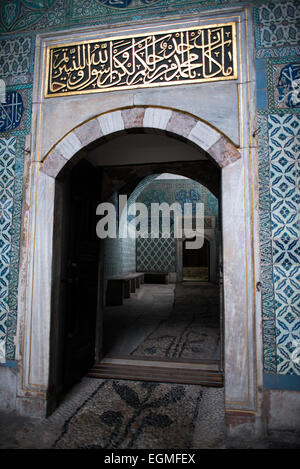 ISTANBUL, Turkey / Türkiye — The corridor outside the main entrance of the Harem, separating the living quarters of the family, concubines, and Sultan from the Harem Eunuchs. The door leads out into the Nobet Yeri, the sentry post, which is connected to the three main sections of the Harem. The Imperial Harem was the inner sanctum of the Topkapi Palace where the Sultan and his family lived. Standing on a peninsular overlooking the Bosphorus Strait and Golden Horn, Topkapi Palace was the primary residence of the Ottoman sultans for approximately 400 years (1465–1856) of their 624-year reign. Stock Photo