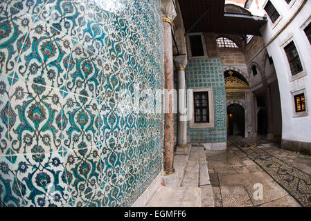 ISTANBUL, Turkey / Türkiye — The corridor outside the main entrance of the Harem, separating the living quarters of the family, concubines, and Sultan from the Harem Eunuchs. The door leads out into the Nobet Yeri, the sentry post, which is connected to the three main sections of the Harem. The Imperial Harem was the inner sanctum of the Topkapi Palace where the Sultan and his family lived. Standing on a peninsular overlooking the Bosphorus Strait and Golden Horn, Topkapi Palace was the primary residence of the Ottoman sultans for approximately 400 years (1465–1856) of their 624-year reign. Stock Photo