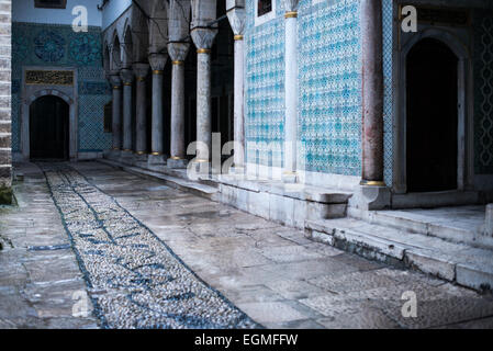 ISTANBUL, Turkey / Türkiye — The corridor outside the main entrance of the Harem, separating the living quarters of the family, concubines, and Sultan from the Harem Eunuchs. The door leads out into the Nobet Yeri, the sentry post, which is connected to the three main sections of the Harem. The Imperial Harem was the inner sanctum of the Topkapi Palace where the Sultan and his family lived. Standing on a peninsular overlooking the Bosphorus Strait and Golden Horn, Topkapi Palace was the primary residence of the Ottoman sultans for approximately 400 years (1465–1856) of their 624-year reign. Stock Photo