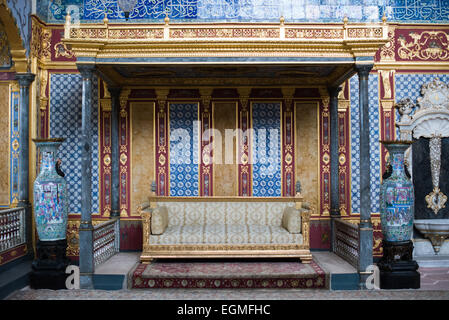 ISTANBUL, Turkey / Türkiye — The Sultan's throne in the ornately decorated Imperial Throne Room in the Harem of Topkapi Palace. The Imperial Harem was the inner sanctum of the Topkapi Palace where the Sultan and his family lived. Standing on a peninsular overlooking the Bosphorus Strait and Golden Horn, Topkapi Palace was the primary residence of the Ottoman sultans for approximately 400 years (1465–1856) of their 624-year reign. Stock Photo