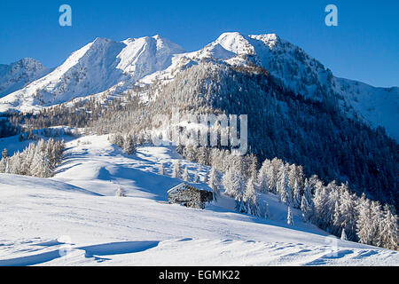 Beautiful alpine scenery with snow and hut Stock Photo
