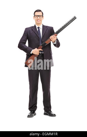Full length portrait of a male bodyguard holding a shotgun isolated on white background Stock Photo