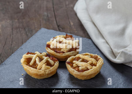 Three Mini apple pies on a slate plate Stock Photo