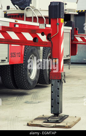 Fire truck outrigger stabilizing legs extended. Stock Photo