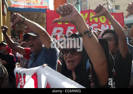 Manila, Philippines. 27th February, 2015. Protesters make the thumbs-down gesture during a rally at Mendiola Bridge near Malacanang Palace. The protesters are calling for the resignation of President Benigno Aquino III over the Mamasapano incident that resulted in the deaths of wanted Malaysian bombmaker Zulkifri 'Marwan' bin Hir, 44 police commandos, 18 Muslim rebels, and 8 civilians. Credit:  Richard James Mendoza/Pacific Press/Alamy Live News Stock Photo