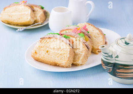 Slices of sponge cake with buttercream on plate served for tea, selective focus Stock Photo