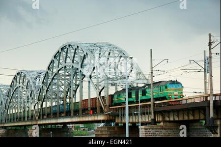 Riga, Latvia. Latvian freight ore train entering Riga central station across the Daugava River rail bridge Stock Photo