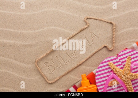 Bulgaria  pointer and beach accessories lying on the sand, as background Stock Photo