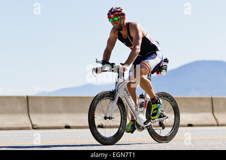 COEUR D ALENE, ID -  JUNE 23: Triathlete on the bike part of the ironman triathlon, June 23 2013 in Coeur d' Alene Idaho Stock Photo