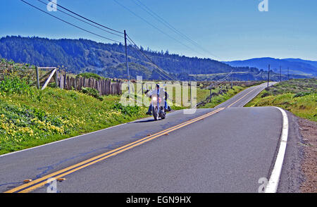 lone mortorcyclist rides on shoreline highway us 1 in sonoma county Stock Photo