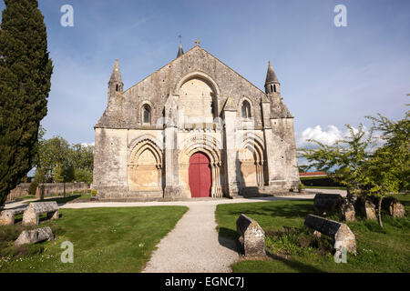 Cemetery and the front of the Church of Saint-Pierre-de-la-Tour d'Aulnay. Stock Photo