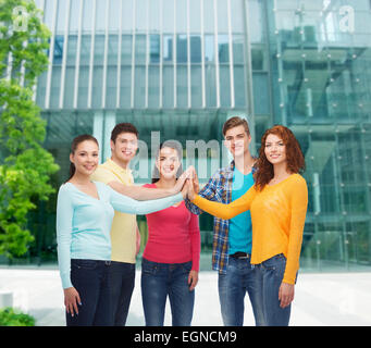 smiling teenagers making high five Stock Photo