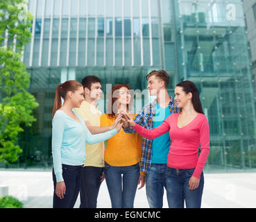 smiling teenagers making high five Stock Photo