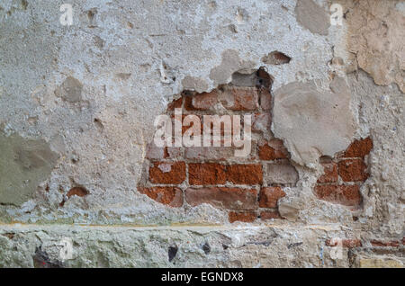 Old grunge plastered wall from a brick. Grunge background, Front view. Stock Photo