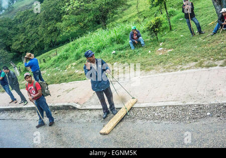 Ocosingo Chiapas, Mexico. 27th February, 2015. Cheerful band of young Zapatistas set up a wood board with nails facing up to halt traffic in both directions & politely board buses to ask for donations to their cause or ask motorists directly. Then the nails are briefly withdrawn to permit vehicle to pass. Apart from the nails, no threats are made Credit:  Dorothy Alexander/Alamy Live News Stock Photo