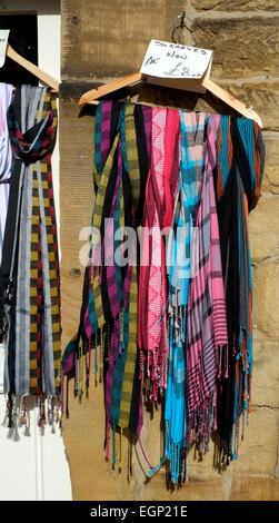 Bakewell,Derbyshire,England UK. Colorful scarves hanging on a wooden hanger. Stock Photo