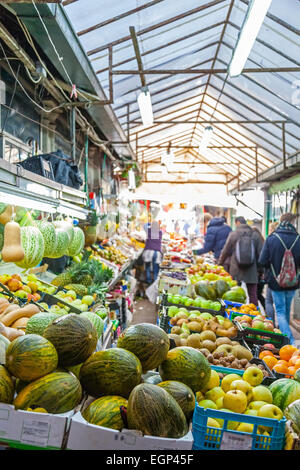 Porto, Portugal. December 29, 2014: Fruit seller and buyers in the interior of the historical Bolhao Market Stock Photo