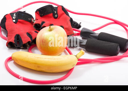 In this photo skinning rope,gloves gym,banana and apple. Stock Photo