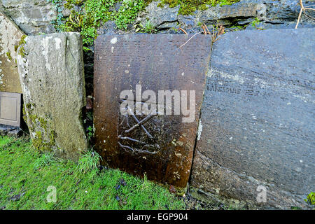 Grave stone with skull and cross bones in graveyard at Saint Augustine's  neo-Gothic church built in 1872 on Derry, Londonderry Stock Photo