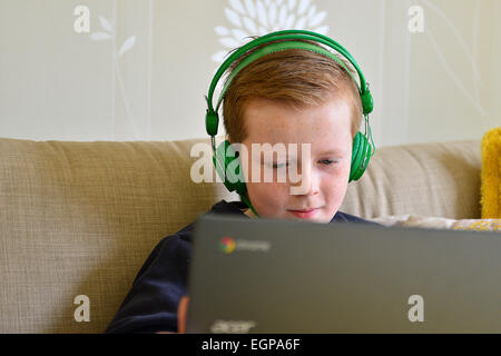 Young boy playing online computer games on laptop. Photo: George Sweeney / Alamy Stock Photo