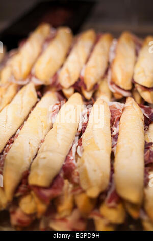 lot of iberian ham panini french bread sandwiches stacked ready to eat Stock Photo
