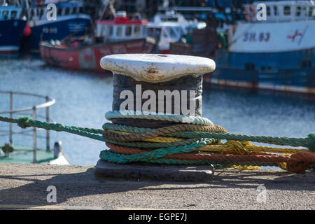 A typical dockside mooring bollard on North Wharf with fishing boat mooring ropes. Stock Photo