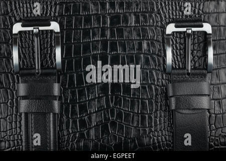Two belt lying on crocodile skin, can be used as background Stock Photo
