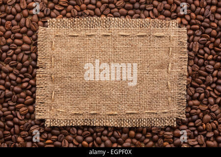 Frame of burlap and coffee beans lying on a white background, with place for your text Stock Photo