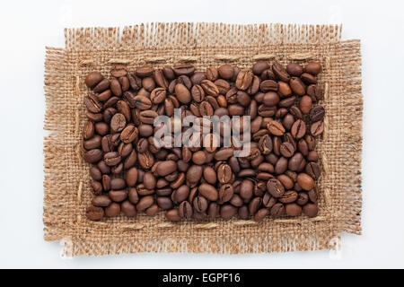 Frame of burlap and coffee beans lying on a white background,can be used as texture Stock Photo