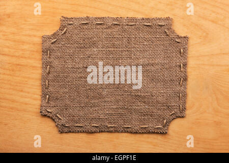 Frame of burlap, lies on a background of wood, with place for your text Stock Photo