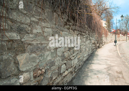long stone wall fence, streets Stock Photo